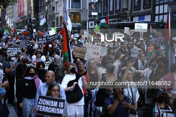 Palestinian supporters march through the streets with flags and signs against the October 2023 Israeli incursion of Gaza, on October 7, 2024...