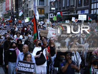 Palestinian supporters march through the streets with flags and signs against the October 2023 Israeli incursion of Gaza, on October 7, 2024...