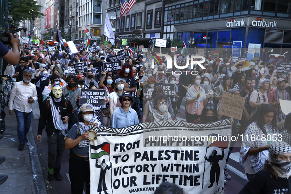 Palestinian supporters march through the streets with flags and signs against the October 2023 Israeli incursion of Gaza, on October 7, 2024...