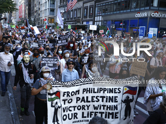 Palestinian supporters march through the streets with flags and signs against the October 2023 Israeli incursion of Gaza, on October 7, 2024...