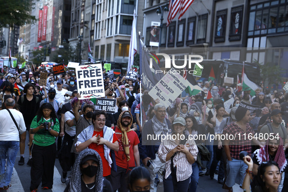 Palestinian supporters march through the streets with flags and signs against the October 2023 Israeli incursion of Gaza, on October 7, 2024...