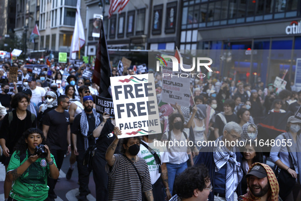 Palestinian supporters march through the streets with flags and signs against the October 2023 Israeli incursion of Gaza, on October 7, 2024...