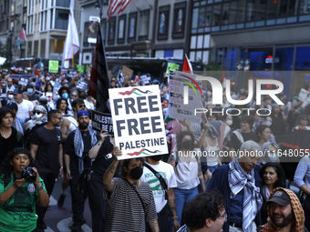 Palestinian supporters march through the streets with flags and signs against the October 2023 Israeli incursion of Gaza, on October 7, 2024...