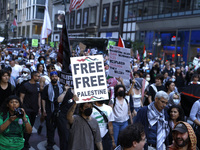 Palestinian supporters march through the streets with flags and signs against the October 2023 Israeli incursion of Gaza, on October 7, 2024...