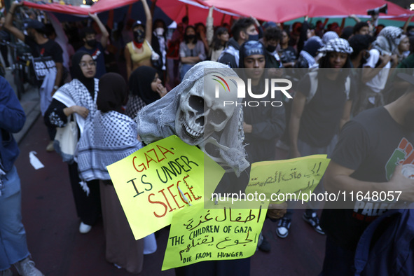 Palestinian supporters march through the streets with flags and signs against the October 2023 Israeli incursion of Gaza, on October 7, 2024...