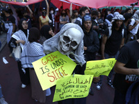 Palestinian supporters march through the streets with flags and signs against the October 2023 Israeli incursion of Gaza, on October 7, 2024...