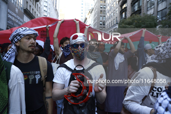 Palestinian supporters march through the streets with flags and signs against the October 2023 Israeli incursion of Gaza, on October 7, 2024...