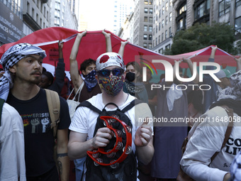 Palestinian supporters march through the streets with flags and signs against the October 2023 Israeli incursion of Gaza, on October 7, 2024...