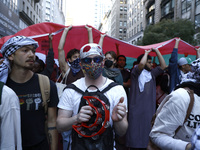 Palestinian supporters march through the streets with flags and signs against the October 2023 Israeli incursion of Gaza, on October 7, 2024...