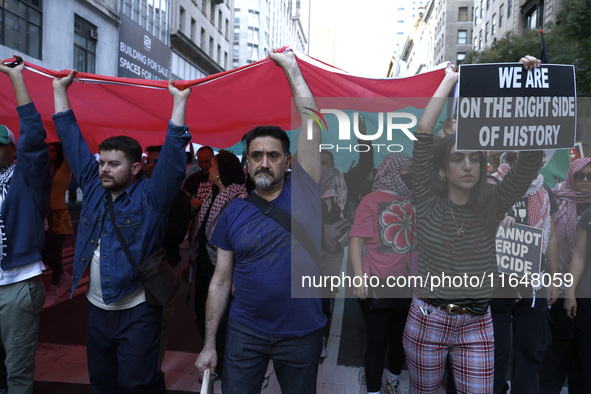 Palestinian supporters march through the streets with flags and signs against the October 2023 Israeli incursion of Gaza, on October 7, 2024...