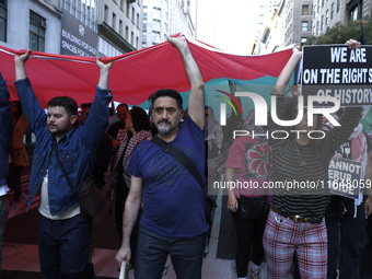 Palestinian supporters march through the streets with flags and signs against the October 2023 Israeli incursion of Gaza, on October 7, 2024...