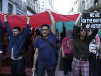 Palestinian supporters march through the streets with flags and signs against the October 2023 Israeli incursion of Gaza, on October 7, 2024...