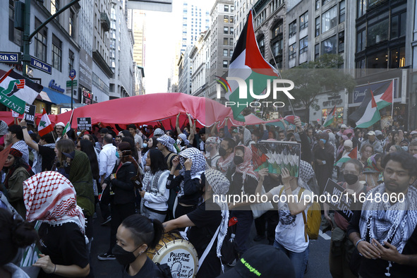 Palestinian supporters march through the streets with flags and signs against the October 2023 Israeli incursion of Gaza, on October 7, 2024...