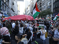 Palestinian supporters march through the streets with flags and signs against the October 2023 Israeli incursion of Gaza, on October 7, 2024...