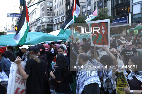 Palestinian supporters march through the streets with flags and signs against the October 2023 Israeli incursion of Gaza, on October 7, 2024...