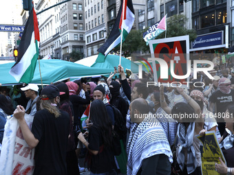 Palestinian supporters march through the streets with flags and signs against the October 2023 Israeli incursion of Gaza, on October 7, 2024...