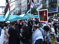 Palestinian supporters march through the streets with flags and signs against the October 2023 Israeli incursion of Gaza, on October 7, 2024...