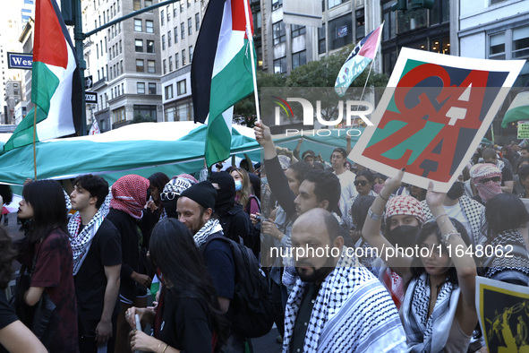 Palestinian supporters march through the streets with flags and signs against the October 2023 Israeli incursion of Gaza, on October 7, 2024...