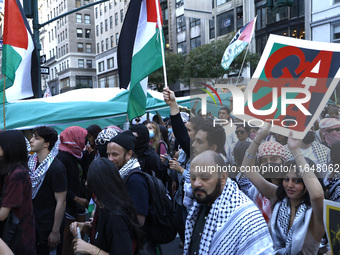 Palestinian supporters march through the streets with flags and signs against the October 2023 Israeli incursion of Gaza, on October 7, 2024...