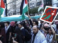 Palestinian supporters march through the streets with flags and signs against the October 2023 Israeli incursion of Gaza, on October 7, 2024...