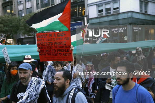 Palestinian supporters march through the streets with flags and signs against the October 2023 Israeli incursion of Gaza, on October 7, 2024...