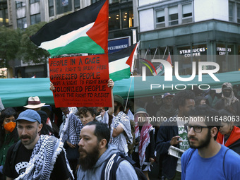 Palestinian supporters march through the streets with flags and signs against the October 2023 Israeli incursion of Gaza, on October 7, 2024...