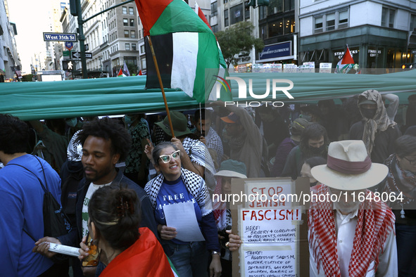 Palestinian supporters march through the streets with flags and signs against the October 2023 Israeli incursion of Gaza, on October 7, 2024...