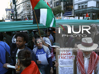 Palestinian supporters march through the streets with flags and signs against the October 2023 Israeli incursion of Gaza, on October 7, 2024...