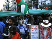 Palestinian supporters march through the streets with flags and signs against the October 2023 Israeli incursion of Gaza, on October 7, 2024...