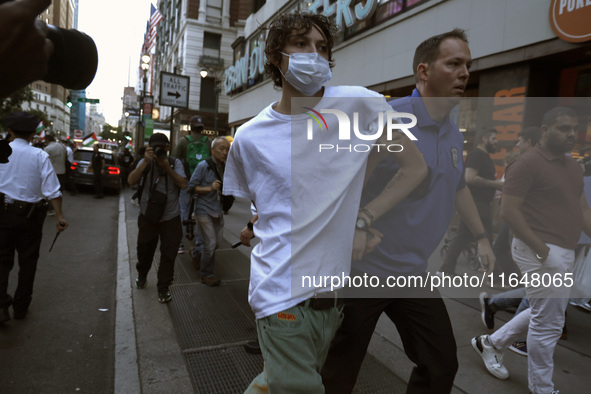 Palestinian supporter is arrested by the New York City police during a march against the October 2023 Israeli incursion of Gaza, on October...