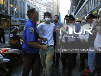 Palestinian supporter is arrested by the New York City police during a march against the October 2023 Israeli incursion of Gaza, on October...