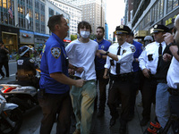 Palestinian supporter is arrested by the New York City police during a march against the October 2023 Israeli incursion of Gaza, on October...