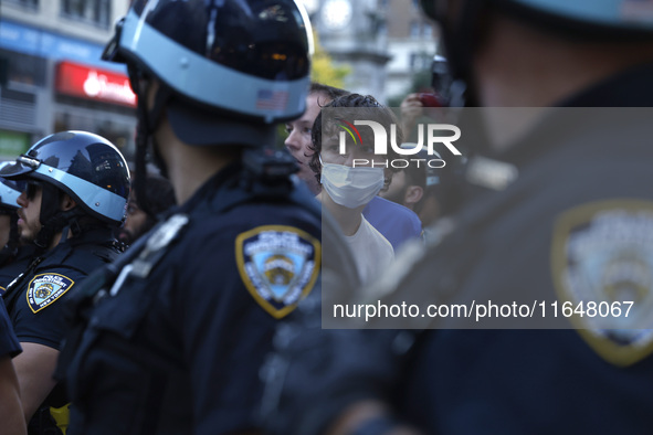 Palestinian supporter is arrested by the New York City police during a march against the October 2023 Israeli incursion of Gaza, on October...