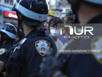 Palestinian supporter is arrested by the New York City police during a march against the October 2023 Israeli incursion of Gaza, on October...