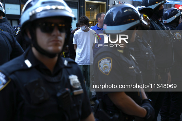 Palestinian supporter is arrested by the New York City police during a march against the October 2023 Israeli incursion of Gaza, on October...