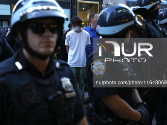 Palestinian supporter is arrested by the New York City police during a march against the October 2023 Israeli incursion of Gaza, on October...