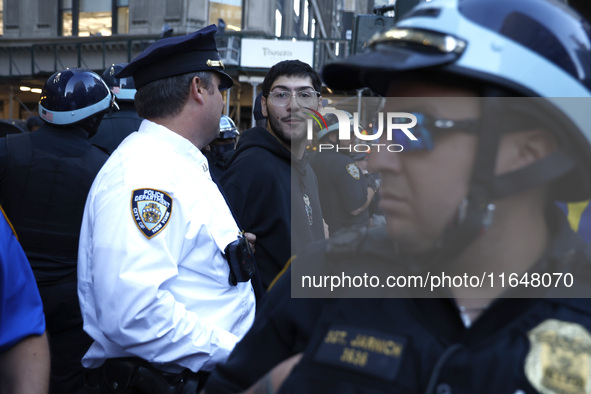 Palestinian supporter is arrested by the New York City police during a march against the October 2023 Israeli incursion of Gaza, on October...