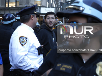 Palestinian supporter is arrested by the New York City police during a march against the October 2023 Israeli incursion of Gaza, on October...