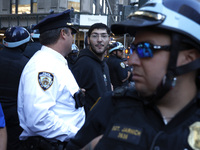 Palestinian supporter is arrested by the New York City police during a march against the October 2023 Israeli incursion of Gaza, on October...