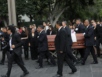 Persons carry a coffin with the body of Ifigenia Martinez during the posthumous funeral tribute in honor of Ifigenia Martinez, 99, in the Ch...