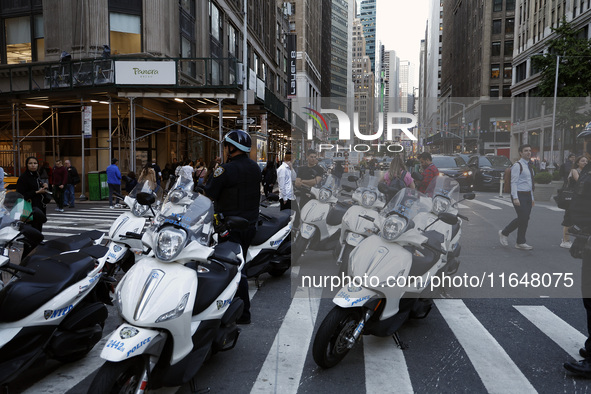 New York City Police motorcycles stand as Palestinian supporters march through the streets with flags and signs against the October 2023 Isr...