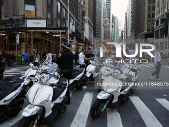 New York City Police motorcycles stand as Palestinian supporters march through the streets with flags and signs against the October 2023 Isr...