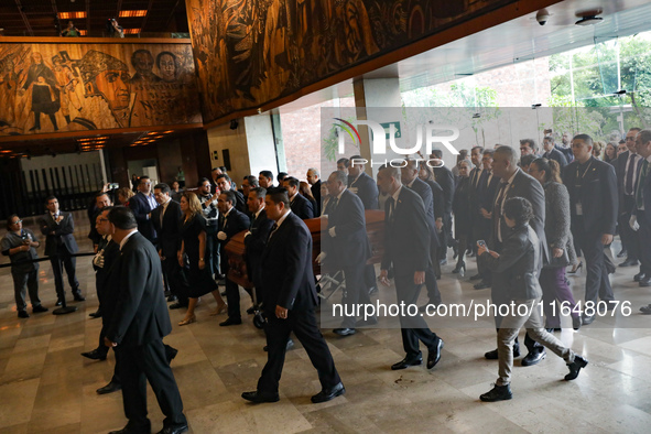 Persons carry a coffin with the body of Ifigenia Martinez during the posthumous funeral tribute in honor of Ifigenia Martinez, 99, in the Ch...