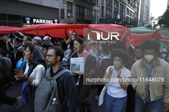 Palestinian supporters march through the streets with flags and signs against the October 2023 Israeli incursion of Gaza, on October 7, 2024...