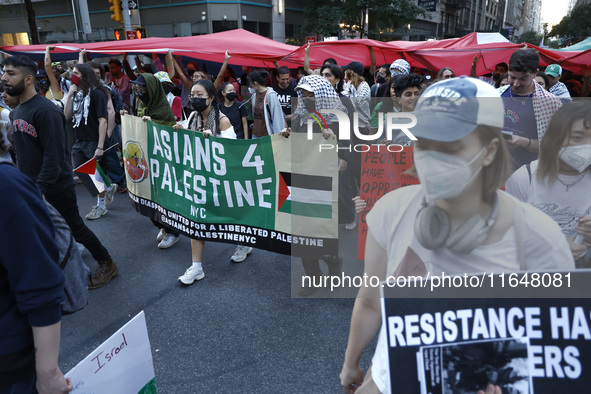 Palestinian supporters march through the streets with flags and signs against the October 2023 Israeli incursion of Gaza, on October 7, 2024...