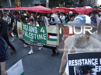 Palestinian supporters march through the streets with flags and signs against the October 2023 Israeli incursion of Gaza, on October 7, 2024...