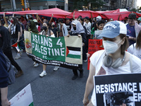 Palestinian supporters march through the streets with flags and signs against the October 2023 Israeli incursion of Gaza, on October 7, 2024...