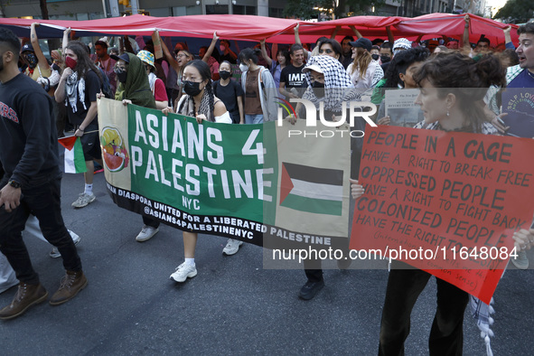 Palestinian supporters march through the streets with flags and signs against the October 2023 Israeli incursion of Gaza, on October 7, 2024...