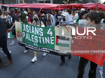 Palestinian supporters march through the streets with flags and signs against the October 2023 Israeli incursion of Gaza, on October 7, 2024...