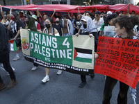 Palestinian supporters march through the streets with flags and signs against the October 2023 Israeli incursion of Gaza, on October 7, 2024...